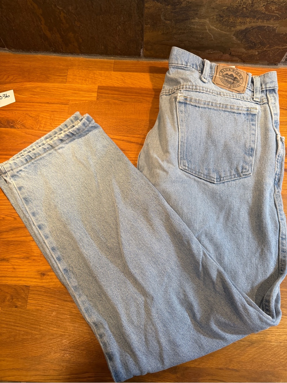 Wrangler Blue Ridge Light Blue Relaxed Fit Men’s Jeans, distressed with holes.